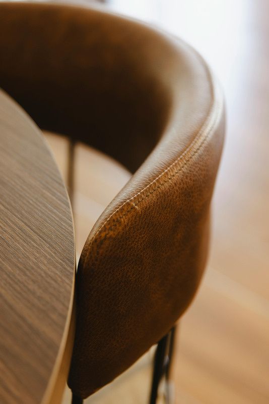 Curved timber and leather chair detail
